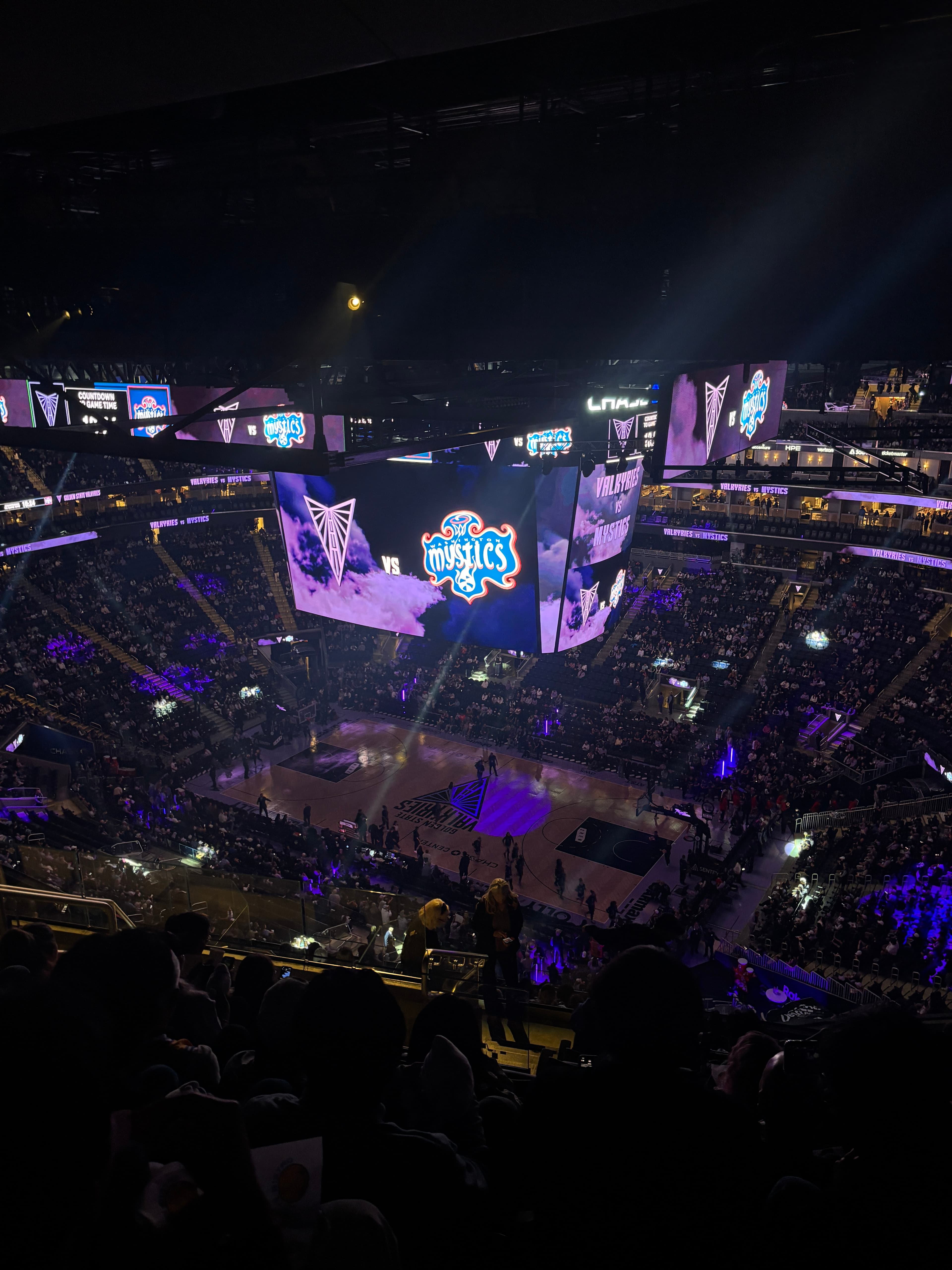 A WNBA game between the Golden State Valkyries and Washington Mystics, viewed from the upper stands.